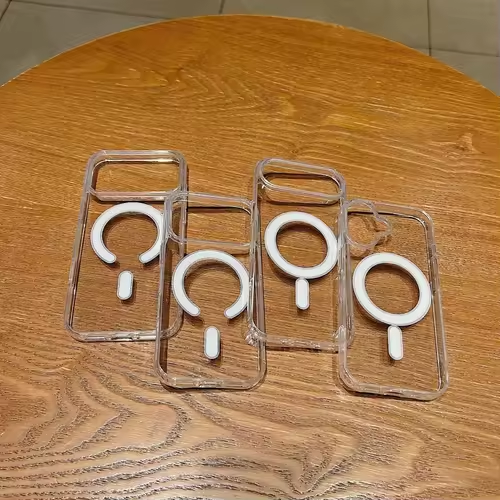 Four white ring stands in clear plastic cases on a wooden surface